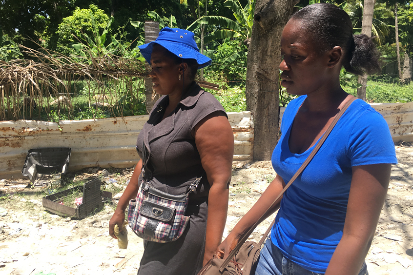 Mirlande Joseph, left, is a well-known figure in certain areas of Port-au-Prince, Haiti. She and other Carter Center-supported health workers such as Maudeline Florient, right, go door to door spreading information about lymphatic filariasis and providing medicines to prevent it. 