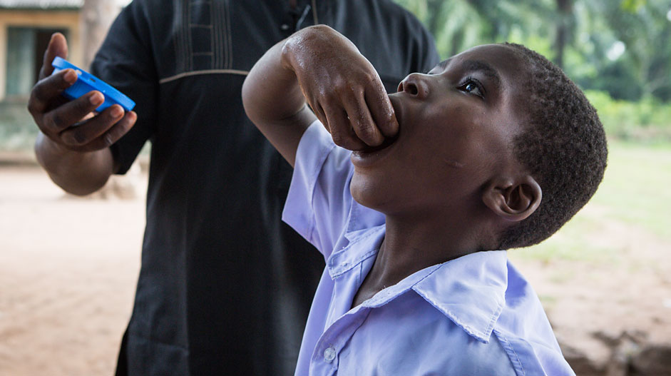 Gideon swallows his praziquantel tablets. The frightening blood in his urine should clear up within a couple of days.